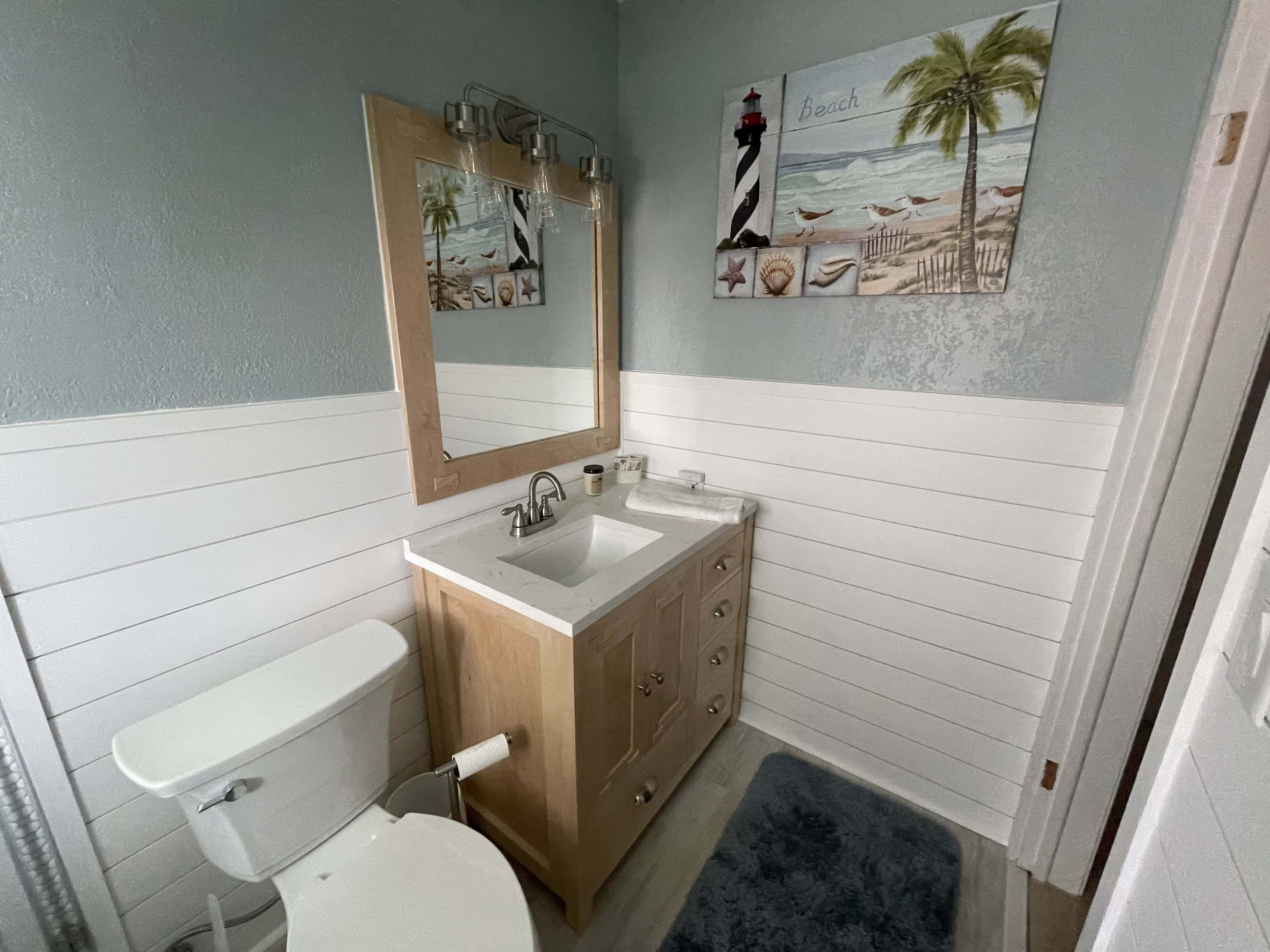 Custom wooden vanity and mirror in bathroom